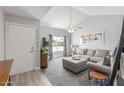 Bright living room features vaulted ceiling, large windows, and neutral color palette at 2444 S Noche De Paz --, Mesa, AZ 85202