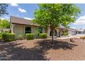 Well maintained front yard and facade with attractive desert landscaping and shade tree at 2616 S El Dorado --, Mesa, AZ 85202