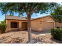 Inviting single-story home with desert landscaping, two-car garage, and covered porch at 30212 N Sunray Dr, San Tan Valley, AZ 85143