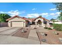 Charming single-story home with a terra cotta roof, a two-car garage, and a well-manicured landscaped front yard at 322 E Gary Cir, Mesa, AZ 85201