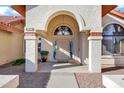 Elegant front entryway with decorative archway, columns, and a detailed front door at 322 E Gary Cir, Mesa, AZ 85201