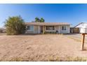 Inviting single-story home showcasing desert landscape and a cozy front porch, perfect for relaxing evenings at 3256 W Libby St, Phoenix, AZ 85053