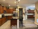 Modern kitchen boasts sleek black countertops, stainless steel appliances, and a large central island at 3845 E Yeager Dr, Gilbert, AZ 85295
