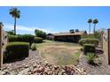 Backyard with potential, ready for landscaping with privacy hedges and rock detail at 3848 W Kings Ave, Phoenix, AZ 85053