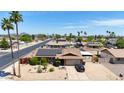 Charming single-Gathering home with a well-manicured desert front yard, solar panels, and a paved driveway at 3848 W Kings Ave, Phoenix, AZ 85053