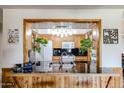 View of kitchen with wooden cabinets, black countertops, and pass-through to another room at 3848 W Kings Ave, Phoenix, AZ 85053