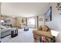 Bright living room features neutral tones, comfortable seating, and natural light from a large window at 3848 W Kings Ave, Phoenix, AZ 85053
