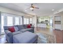 Open-concept living room with hardwood floors, a comfortable seating area, and view into kitchen at 3921 W Jasper Dr, Chandler, AZ 85226