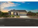 Charming single-story home featuring a two-car garage, well-maintained landscaping, and a welcoming entrance at 435 E Shellie Ct, Casa Grande, AZ 85122