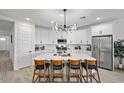 Modern kitchen with white cabinets, stainless steel appliances, and a large island with seating at 435 E Shellie Ct, Casa Grande, AZ 85122