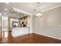 Open-concept dining area showcases hardwood floors and view into the kitchen area at 4401 N 24Th Pl, Phoenix, AZ 85016
