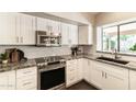 Updated kitchen with white cabinets, stainless steel appliances, and granite countertops at 5132 E Grandview Rd, Scottsdale, AZ 85254