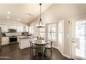 Open-concept kitchen and dining area featuring granite countertops and stainless steel appliances at 5132 E Grandview Rd, Scottsdale, AZ 85254