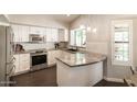 Bright kitchen featuring stainless steel appliances, granite countertops, and white cabinetry at 5132 E Grandview Rd, Scottsdale, AZ 85254