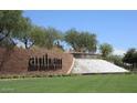 Beautiful Anthem by Del Webb brick signage with a cascading water feature and lush green landscaping at 5490 W Trenton Way, Florence, AZ 85132