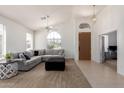 Bright living room boasts high ceilings, plush carpet, a comfortable sectional, and lots of natural light at 7231 W Lone Cactus Dr, Glendale, AZ 85308