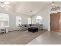 Bright and airy living room with a comfortable sectional sofa, high ceilings, and large windows for natural light at 7231 W Lone Cactus Dr, Glendale, AZ 85308