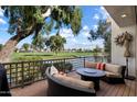Outdoor balcony with comfortable seating and picturesque views of the golf course and water at 7272 E Gainey Ranch Rd # 29, Scottsdale, AZ 85258