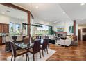 Open-concept living space with fireplace and views of a golf course, seamlessly connecting to the kitchen at 7272 E Gainey Ranch Rd # 29, Scottsdale, AZ 85258