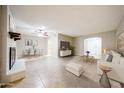 Open-concept space with tile flooring, a decorative fireplace, and a view into the dining area at 7439 E Ed Rice Ave, Mesa, AZ 85208