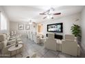 Home theater with reclining seats, ceiling fans, and a flat-screen TV for immersive entertainment at 7439 E Ed Rice Ave, Mesa, AZ 85208