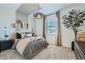 Inviting bedroom with neutral tones, stylish lighting, and a comfortable bed at 8048 E Paloma Ave, Mesa, AZ 85212