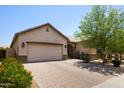 Lovely single-story home featuring a two-car garage, neutral color palette, and a brick-paved driveway at 8113 S 42Nd Dr, Laveen, AZ 85339