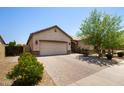 Beautiful single-story home featuring a two-car garage, neutral color palette, and a brick-paved driveway at 8113 S 42Nd Dr, Laveen, AZ 85339