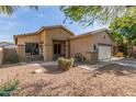 Charming home exterior with a front porch, desert landscaping, and an attached two-car garage at 839 E Leo Pl, Chandler, AZ 85249