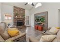 Inviting living room featuring a stone fireplace, plush seating, and modern entertainment setup at 9125 E Gelding Dr, Scottsdale, AZ 85260