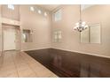 Spacious living room with wood floors, recessed lighting, lots of windows, and high ceilings at 9207 W Kirby Ave, Tolleson, AZ 85353