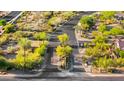 An aerial view shows a lush green community with manicured landscaping and winding streets at 9532 E Knoll Cir, Mesa, AZ 85207