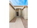 Inviting front entryway with decorative stone and neutral color palette at 9532 E Knoll Cir, Mesa, AZ 85207