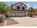 This inviting two-story home features a three-car garage and low-maintenance landscaping at 987 E Divot Dr, Tempe, AZ 85283