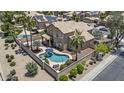 Aerial view of a backyard oasis featuring a large pool, covered patio, and privacy wall at 1244 W Straford Ave, Gilbert, AZ 85233