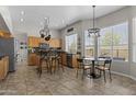 Eat-in kitchen with tile flooring, stainless steel appliances, and a breakfast nook near large windows at 1244 W Straford Ave, Gilbert, AZ 85233