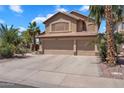 Inviting two-story home with a three-car garage, set amidst lush palm trees and meticulous landscaping at 1264 S Sierra St, Gilbert, AZ 85296
