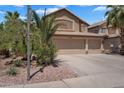 Inviting two-story home with a three-car garage complemented by desert landscaping at 1264 S Sierra St, Gilbert, AZ 85296