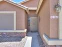 Inviting front entryway features a secure screen door and decorative stone accents at 1563 E Peregrine Trl, Casa Grande, AZ 85122