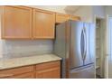 Stainless steel refrigerator and spacious pantry in a well-organized kitchen space at 1563 E Peregrine Trl, Casa Grande, AZ 85122