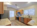Bright kitchen with granite countertops, stainless steel appliances, and ample natural light at 1563 E Peregrine Trl, Casa Grande, AZ 85122