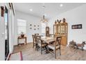 Inviting dining area featuring wood-style tile floors and modern lighting fixture at 17003 W Alameda Rd, Surprise, AZ 85387