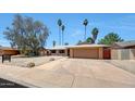 Charming single-story home with a two-car garage, low maintenance desert landscaping, and a welcoming entrance at 1712 E Manhatton Dr, Tempe, AZ 85282