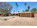 Charming single-story home with a two-car garage, low maintenance desert landscaping, and a welcoming entrance at 1712 E Manhatton Dr, Tempe, AZ 85282