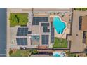 Aerial view of home with solar panels on roof and a sparkling in-ground swimming pool in the backyard at 1755 N 74 Th Pl, Mesa, AZ 85207