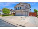 Charming two-story home features a well-manicured lawn, mature trees, and a spacious two-car garage at 1755 N 74 Th Pl, Mesa, AZ 85207