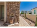 Serene courtyard featuring a decorative fountain, brick accents, and desert landscaping at 22682 E Indiana Ave, Queen Creek, AZ 85142