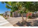 A picturesque home with brick accents, desert landscaping, and a spacious paved driveway at 22682 E Indiana Ave, Queen Creek, AZ 85142