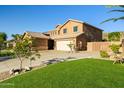 Charming home featuring a well-maintained lawn, desert landscaping, and a spacious driveway at 24645 N 65Th Ave, Glendale, AZ 85310
