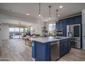Modern kitchen open to dining area, with stainless steel appliances, and a kitchen island with a sink at 25560 N 164Th Dr, Surprise, AZ 85387